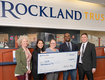 Members of EDEN posing with their giant fifteen thousand dollar check from Rockland Trust's Charitable Foundation.