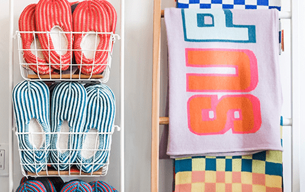 Adult striped slippers and towels sold by Salte.